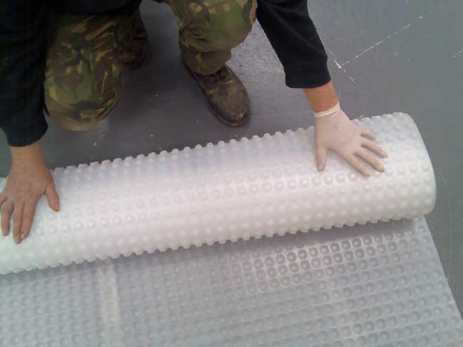 Kontract Membrane being rolled out onto a floor - no fixings required.