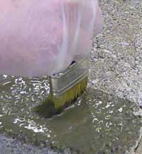 Tanking Slurry being brushed onto concrete block